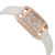 An image of a pre-owned women's Hermès Cod Joaillier wristwatch, viewed from a slightly angled side perspective. The watch features a rectangular face with a rose gold-tone bezel, adorned with sparkling gemstones. It has a white leather strap and elegant, intricate detailing on the dial, which includes rose gold-tone hands. The angle highlights the luxurious materials and craftsmanship, offering a close-up view of the watch's design.