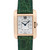 An image of a pre-owned women's Cartier wristwatch. The watch is shown from a front-facing angle, centered in the frame, capturing its rectangular face with a rose gold casing and a green leather strap. The dial is adorned with diamond hour markers and features blue hands. The image is taken at a close distance, highlighting the intricate details and the brand name on the dial.
