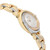 An image of a pre-owned Cartier luxury wristwatch for women, presented in a side profile view opposite the crown. The watch, captured at a close distance and angled to show the side and part of the watch face, features a round shape with a white dial pattern. It has a gold bezel adorned with diamonds, and the band is made of intertwined links of rose gold, white gold, and yellow gold. The case material matches the band, providing an elegant contrast of colors and finishes.