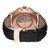 An image of a pre-owned Zenith men's wristwatch with an exhibition caseback, viewed from the back at a slight angle. The watch features a round case made of rose gold and a black leather band with a deployant clasp. The watch is positioned horizontally in the center of the frame, with the clasp on the right side partially open, showcasing the rose gold interior and the Zenith star logo. Visible mechanical components can be seen through the transparent caseback. The image is taken from a close distance, providing a clear view of the textures and details.Pre-owned in Good condition. Minor signs of wear on the strap.

