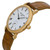 An image of a pre-owned Patek Philippe women's wristwatch in a casual style, captured from a side profile angle that clearly shows the crown. The watch features a round yellow gold case with a gold bezel and a white dial. Roman numeral hour markers are visible on the dial, along with a small seconds subdial. It's fitted with a brown leather strap showing light signs of wear. The image is taken at a close distance, focusing on the side of the watch to emphasize its design and the texture of the leather band.