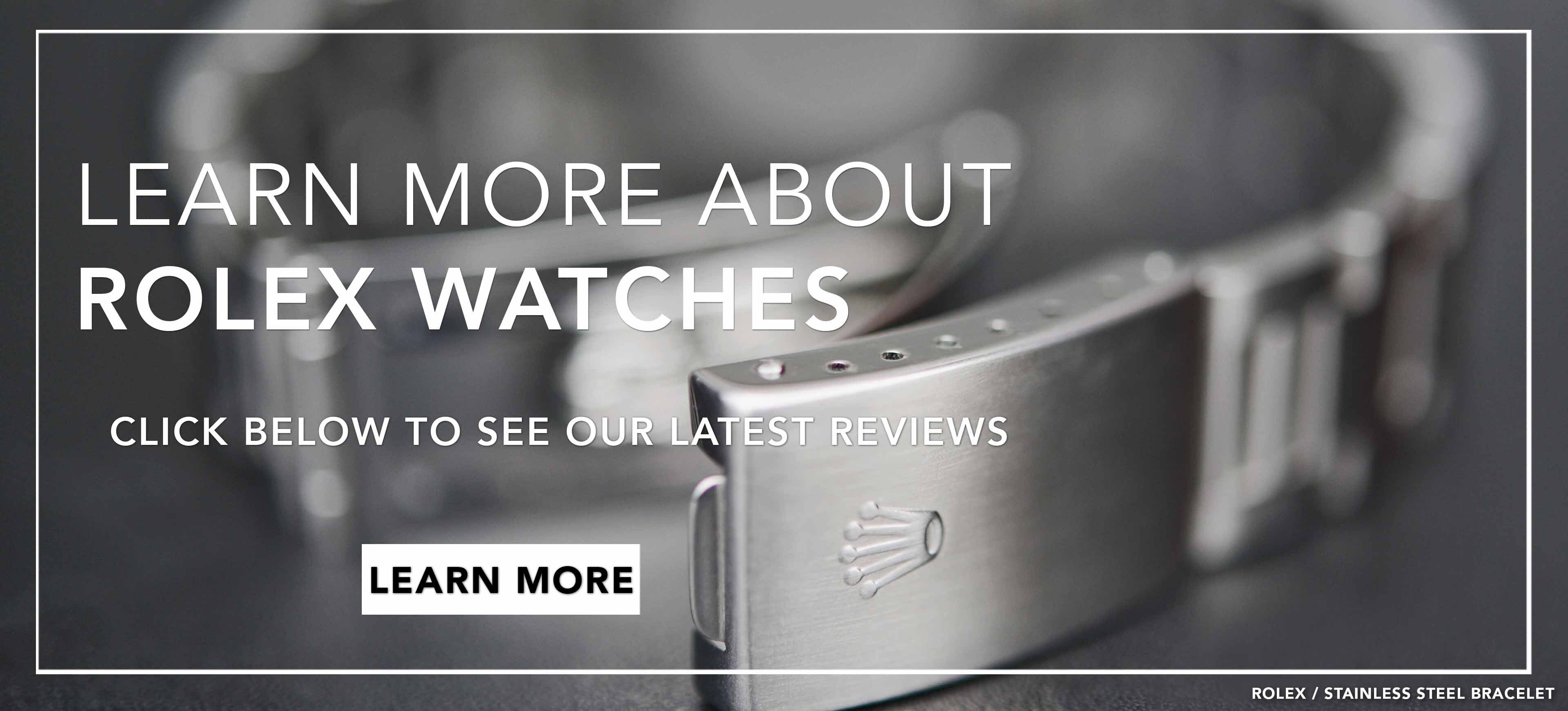 Image of a stainless steel Rolex clasp  resting on an obscure black leather surface