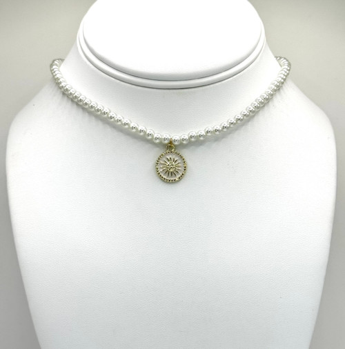 White pearl Necklace with gold findings. with white and gold sun pendant.