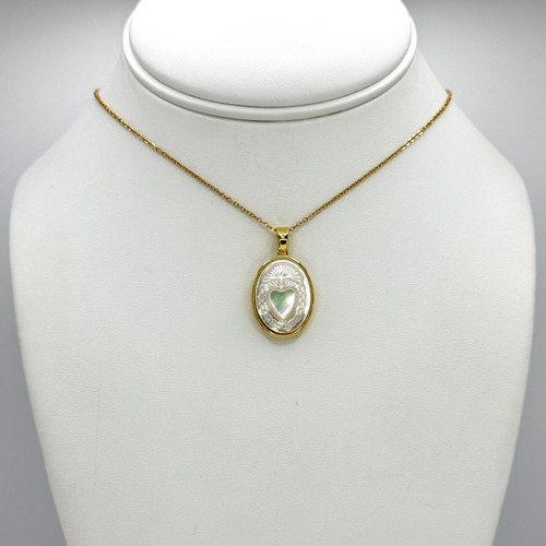 Gold Chain with gold adjustable findings, with Oval Pendant with White Heart inside.