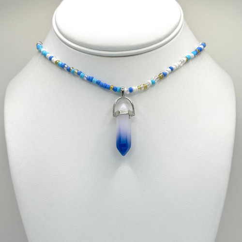 Blue and white crystal pendant on a beaded chain with 16inch to 18inch adjustable silver findings.