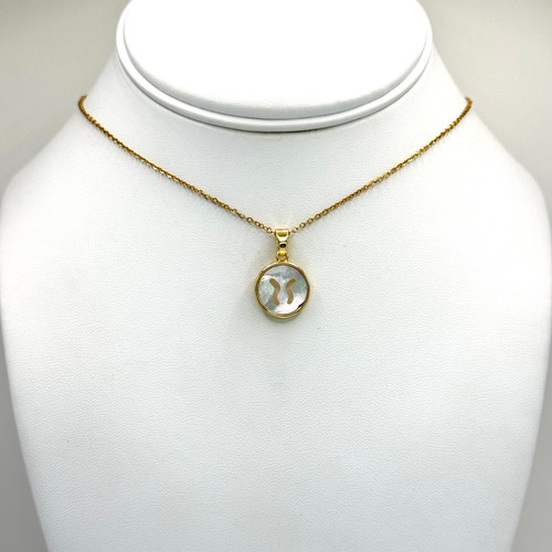 Mother of pearl round zodiac Taurus pendant on a gold box chain with gold findngs.
