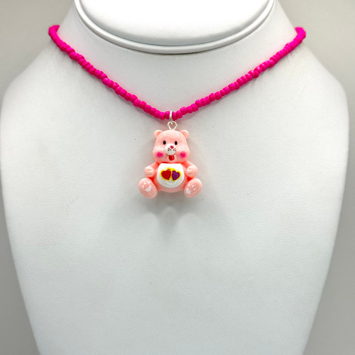Pink care bear pendant on pink beaded chain with 16inch to 18inch adjustable findings.