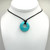 Turquoise Round Crystal hollow Pendant on a cord.