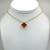 Gold and red clover necklace pendant on a stationary chain with gold findings.