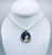 Jasmine themed pendant on a white pearl necklace with gold findings.