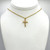 Plastic diamond gold cross pendant on a gold chain with gold clasps.