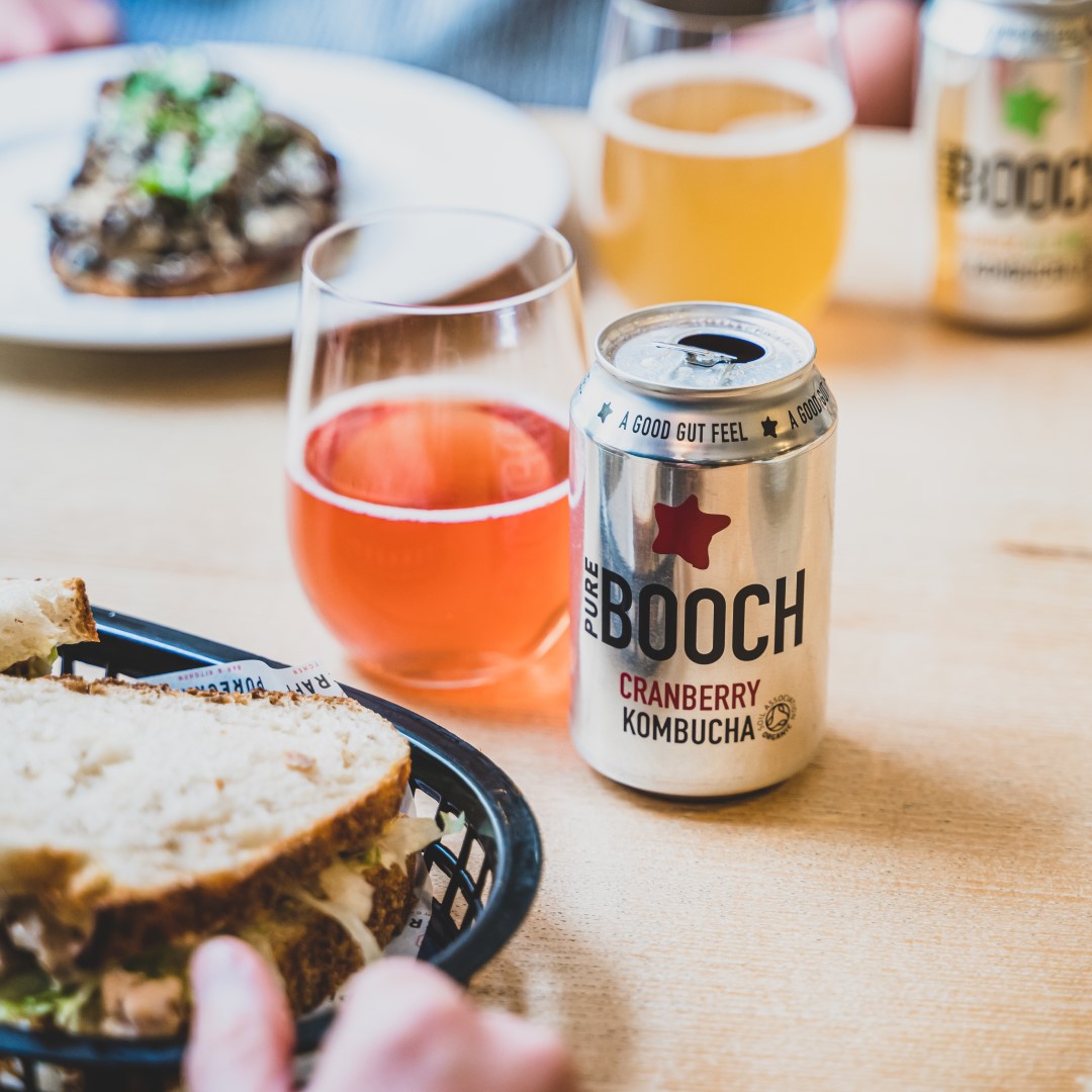 A can of Pure Booch kombucha sat on a table