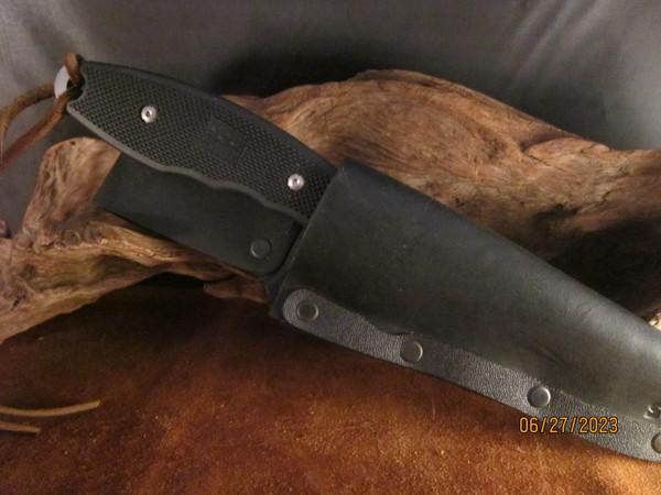 Sandwiched leather sheath with riveted protective strip