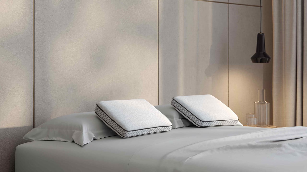 FORM CryoPhase Pillow on a made bed with light bedding