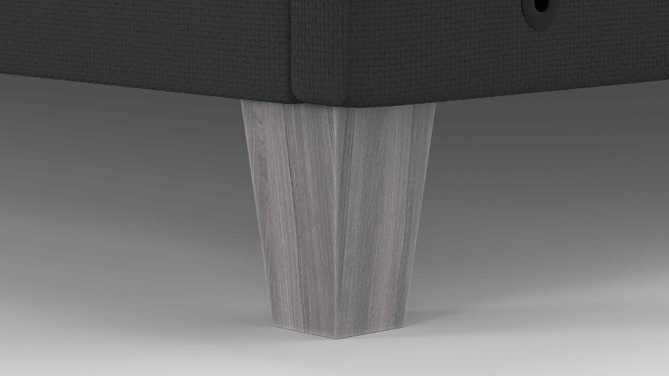 Close-up of a faux wood leg on the FORM Upholstered Foundation