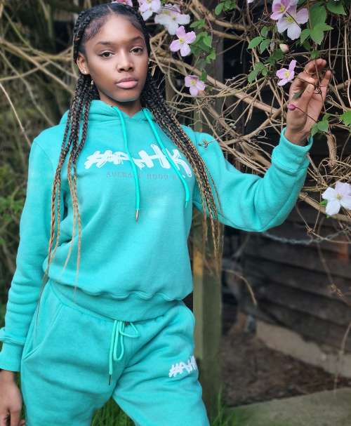 Girl modelling Average Hood Kid women's fitted jogger set in turquoise