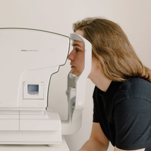 Women having eye screening test Women having eye screening test