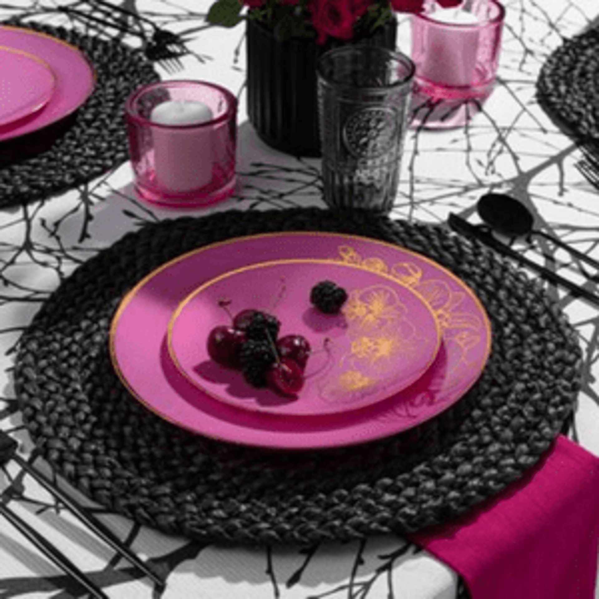 Black plastic and paper plates, napkins, cups, bowls, and utensils