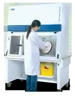 Esco Streamline SLC-RABS compounding aseptic containment isolator, 4 ft, two oval gloveports, with sharps disposal containers on the motorized stand In use at standing work height. Cabinet pictured is a positive-pressure unit; the cabinet is identical across pressure schemes.