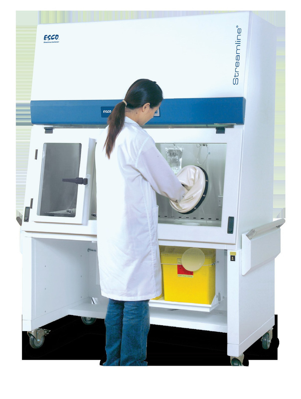 Esco Streamline SLC-RABS compounding aseptic containment isolator, 4 ft, two oval gloveports, with sharps disposal containers on the motorized stand In use at standing work height. Cabinet pictured is a positive-pressure unit; the cabinet is identical across pressure schemes.