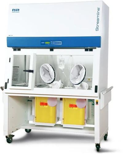 Esco Streamline SLC-RABS compounding aseptic containment isolator, 4 ft, two oval gloveports; this configuration ships with a plain work tray Shown with yellow sharps containers. Cabinet pictured is a positive-pressure unit; the cabinet is identical across pressure schemes.