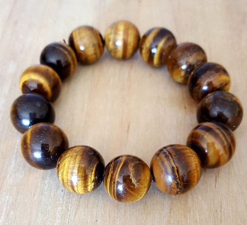  This Tigers Eye Bracelet is brownish with gold sashes. I love this beautiful stone; it reminds me of an inner tree trunk and its stripes of strength. Tiger's Eye is pure protection. when I was a kid, I held it every night because I was feeling things I was unsure of. There were spirits or energy around me that I was not educated about, especially because I couldn't see, only feel the presence of a visitor. Tiger's Eye totally warded off that energy so I could sleep. Copyright © DeMarco,J. (2019) High Vibes Crystal Healing. Florida: Llewellyn Publishing
 Crystal Stone bracelet is chosen, spiritually cleansed and packaged with an abundance of gratitude and high vibe positive energy. 
