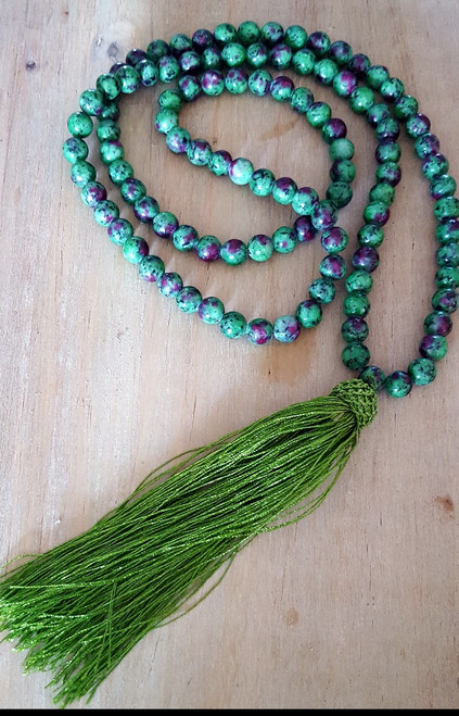 Ruby Zoisite Mala Necklace, Ruby Zoisite is a green crystal with beautiful flecks of pink, Ruby Zoisite almost looks like a wonderful piece of candy (but don't eat or ingest this beauty)! Ruby Zoisite is a motivator stone. It is great for recovery  after an illness, helps you realize your own ideas, stimulates fertility, and makes you creative. It helps you with awareness, positive self esteem, and makes you feel you can support yourself and what you need to do in life. I call it the getter done stone. When I use it I feel like I have a personal coach putting a fire under my butt to get me going: vitality galore! Copyright © DeMarco,J. (2019) High Vibes Crystal Healing. Florida: Llewellyn Publishing
Mala necklace is chosen, spiritually cleansed and packaged with an abundance of gratitude and high vibe positive energy. 