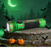Olight Seeker 4 Pro Zombie Green flashlight resting on stone with bats, pumpkins, and a neon green moon background.
