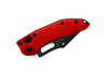 Knife shown closed, highlighting red handle contour and triangular texture pattern.