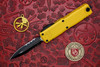 Microtech UTX-85 Gen IV open showing double edge partially serrated blade and yellow handle front view