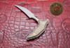Reverse side view of the Microtech Marfione Select Bastinelli Bee fixed blade showing titanium handle contours and apocalyptic finish.