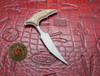 Close-up angled view of the Microtech Bastinelli Bee push dagger featuring apocalyptic blade finish and titanium handle with Defense Outfitters logo.