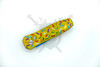 Closed Sprinkle Snap automatic knife with yellow sprinkle pattern aluminum handle.