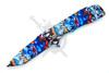 Open blue alien inspired tanto pocket knife with coated black plain edge blade and colorful tropical artwork handle
