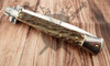 Back side of the closed Italian stiletto showing natural stag texture and polished bolsters