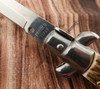 Close-up of the Frank Beltrame tang stamp and polished steel bolster