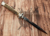 Reverse side of Frank Beltrame Italian stiletto automatic knife showing polished bayonet blade and stag horn handle