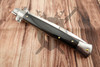 Opposite side of the closed Frank Beltrame automatic knife highlighting the natural buffalo horn handle