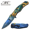 Masters Collection Ballistic Medusa spring-assisted knife shown open and closed with embossed blue and gold mythology-themed artwork and a black pocket clip.