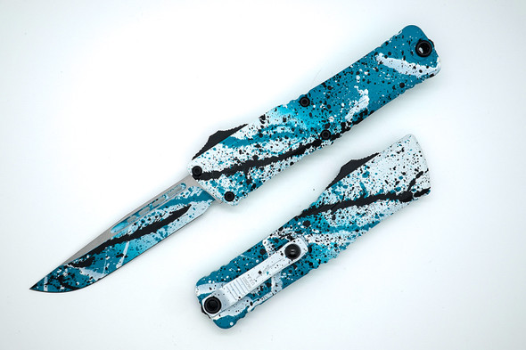 Microtech Combat Troodon Gen III OTF knife with turquoise, white, and black splatter handle and M390 drop point blade Microtech Combat Troodon Gen III OTF knife with turquoise, white, and black splatter handle and M390 drop point blade