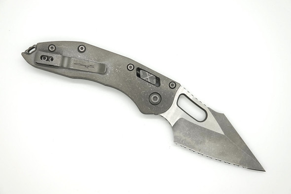 Apocalyptic titanium handle with pocket clip and RAM LOK bar visible.