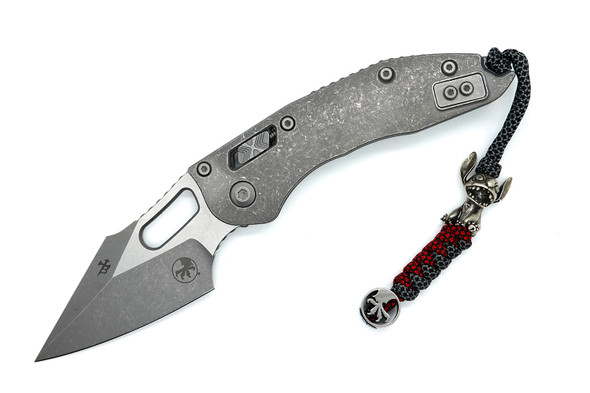 Close-up of the Stitch RAM-LOK open, showing apocalyptic finish titanium handle and M390MK blade.