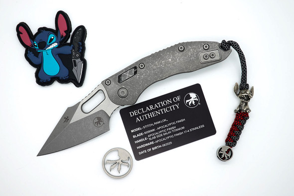 Full product layout of Microtech Stitch RAM-LOK knife with extras including challenge coin, PVC patch, and lanyard bead.