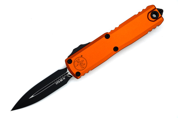 Open Microtech UTX-85 Gen IV OTF Knife showing black double-edge dagger blade and orange machined aluminum handle.