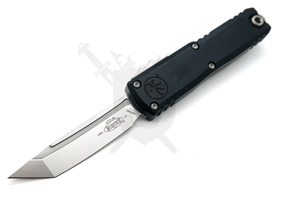 Microtech UTX-85 Gen IV OTF automatic knife with stonewashed M390MK tanto blade and black aluminum handle shown open.