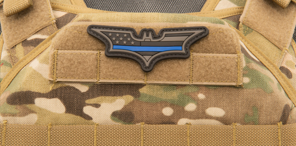 Batman US Flag PVC morale patch in dark gray with blue stripe mounted on tactical vest loop panel