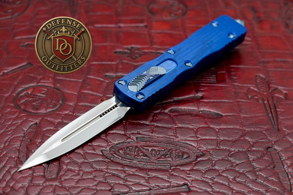 Marfione Custom Dirac OTF knife open with mirror polished double edge blade and blue handle on Microtech display mat