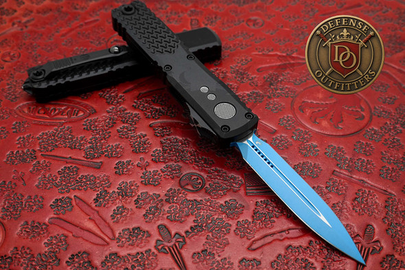 Microtech Ultratech Gen IV Jedi Knight open with blue double edge blade and black handle on red background