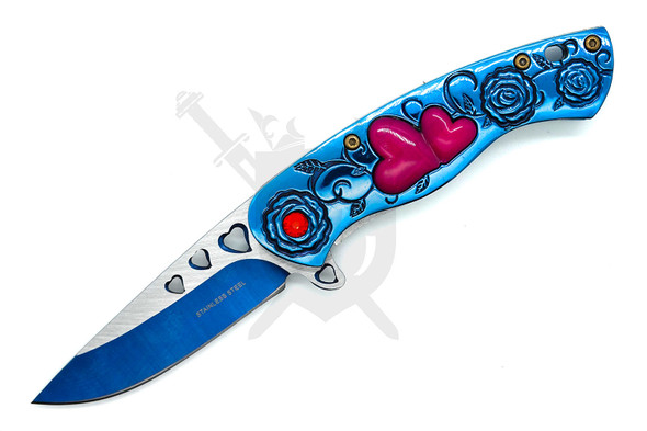 Close-up of blue LOVE assisted knife with heart cutout blade and engraved floral handle