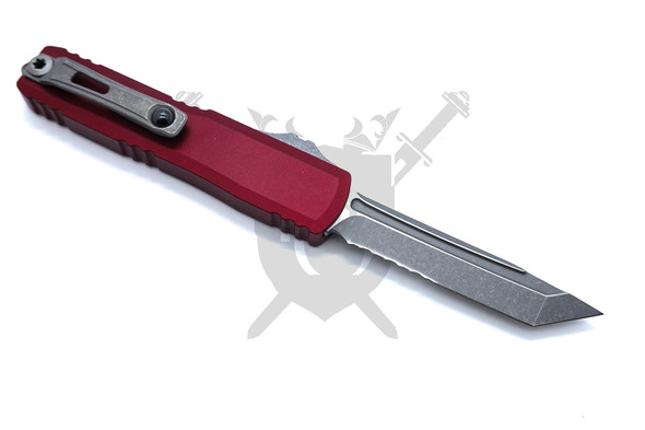 Rear view of Microtech UTX-70 Gen IV Merlot automatic knife showing partial serrated apocalyptic tanto blade and pocket clip